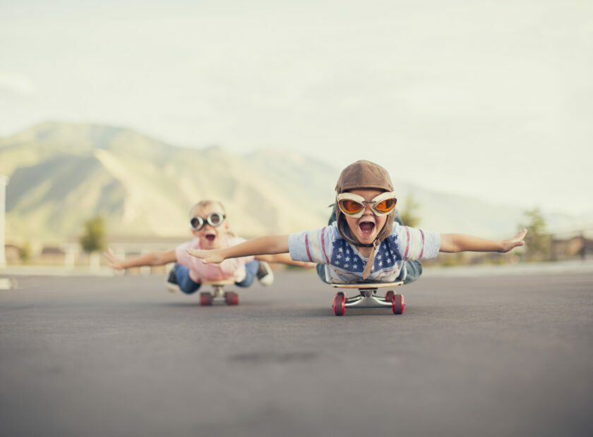 Young Boy and Girl Imagine Flying On Skateboard