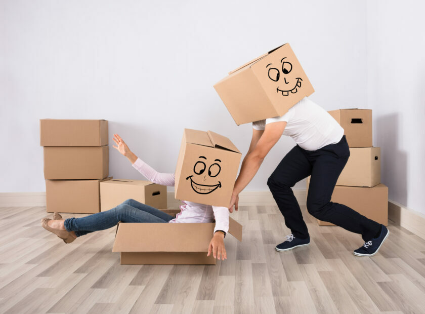 Man Pushing A Woman On Cardboard