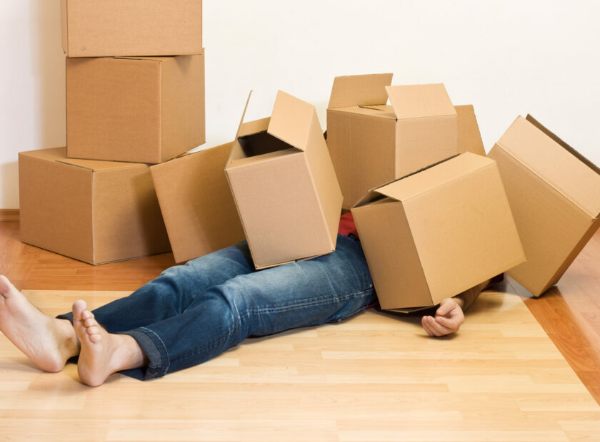 Man covered in cardboard boxes - moving concept