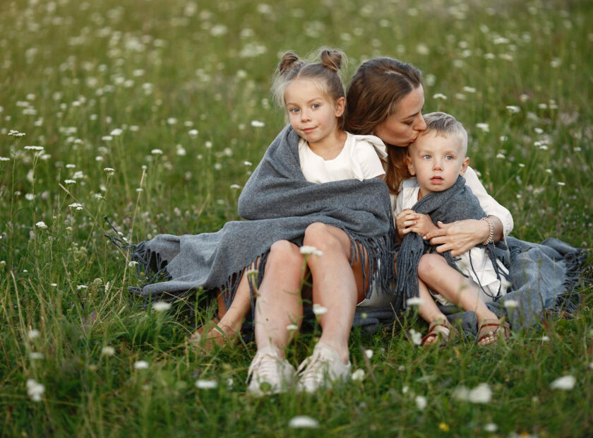 Mother with son and daughter resting in the park.